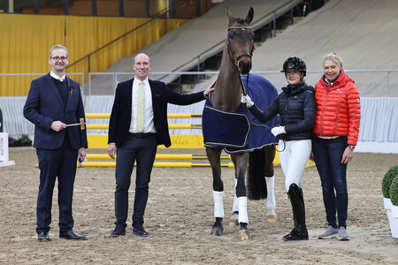 Fahr-Well v. Fahrenheit/Rubin-Royal mit Ausstellerin Anja Plönzke (rechts), Auktionator Bernd Hickert, Auktionsleiter Wilken Treu und Reiterin Ann-Christin Feix. | © Hannoveraner Verband (frei)